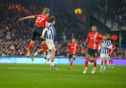 Daiki Hashioka heads the ball forward