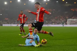 A sliding tackle takes the ball away from Alfie Doughty