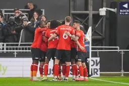 Happy Hatters in a huddle as they celebrate Jacob Brown`s goal