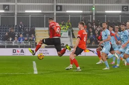Carlton Morris goes airbourne as he goes for the ball