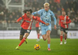 Tahith Chong is held back by Rubin Colwill