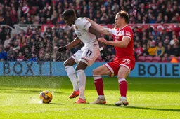 Elijah Adebayo controls the ball and catches the spray