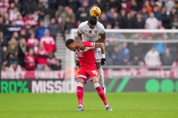 Teden Mengi climbs over Delano Burgzorg to head the ball clear