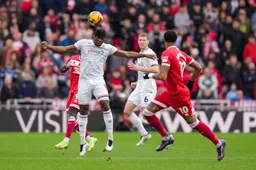 Teden Mengi heads the ball forward