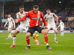 Carlton Morris shields the ball away from former Hatter Cody Drameh