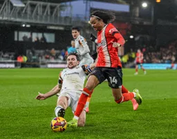 Tahith Chong attempts to move away from a sliding tackle