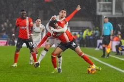 Tahith Chong is strangled as he goes for the ball