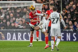 Mark McGuinness goes in bravely for a header