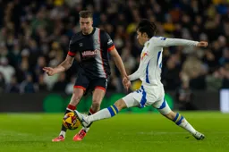 Reece Burke`s pass is blocked by Ao Tanaka