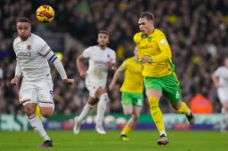 Carlton Morris in a race for the ball against Callum Doyle