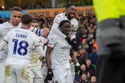 Shandon Baptiste takes a ride on Elijah Adebayo`s back as they celebrate the Town`s first goal