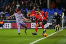 Carlton Morris controls the ball right on the touchline