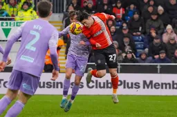 Daiki Hashioka heads the ball away from Liam Cullen