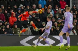 Daiki Hashioka heads the ball away from danger