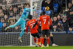 Thomas Kaminski pushes the ball clear