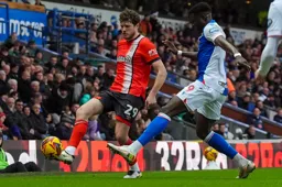Tom Holmes plays the ball down the wing