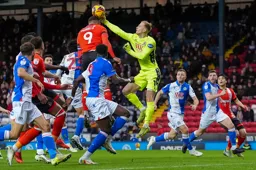 The ball is punched off the head of Carlton Morris