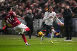 Josh Phillips looks to block the clearance
