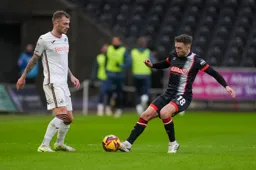 Jordan Clark knocks the ball past a Swans defender