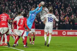 Mark McGuinness is beaten to the ball