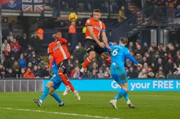 Carlton Morris wins this header