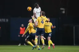 Elijah Adebayo heads the ball forwards