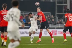 Mark McGuinness gets his head to the ball
