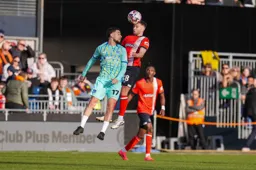 Jordan Clark wins a midfield header