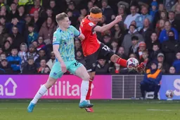 Kal Naismith hooks the ball away