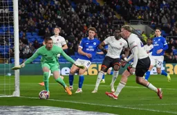 The ball goes narrowly wide