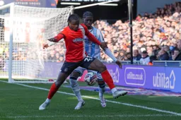 Millenic Alli shields the ball