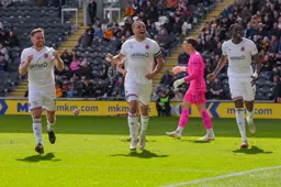 Luton players salute the fluke own goal