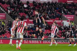 Mark McGuinness heads over
