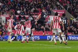 Mark McGuinness wins his header in the box