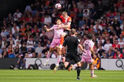 Mark McGuinness heads the ball clear