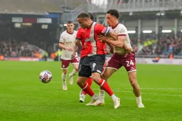 Carlton Morris is manhandled