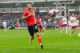 Carlton Morris sees the ball drift out