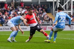 Carlton Morris wins the ball