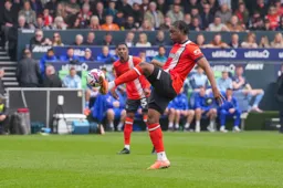 Teden Mengi clears the ball