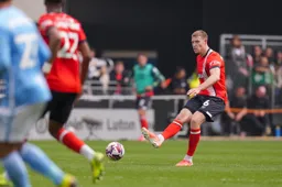 Mark McGuinness slides the ball through