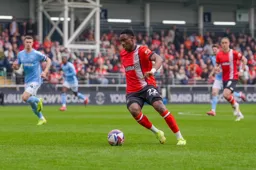 Lamine Fanne looks to lay the ball off