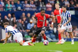 Lamine Fanne looks to lay the ball off