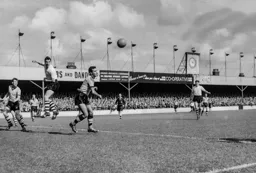 Allan Brown heads across goal