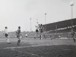 Graham French watches Ian Buxton go for the ball