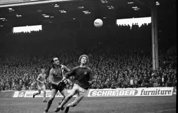 John Aston watches the ball drift wide